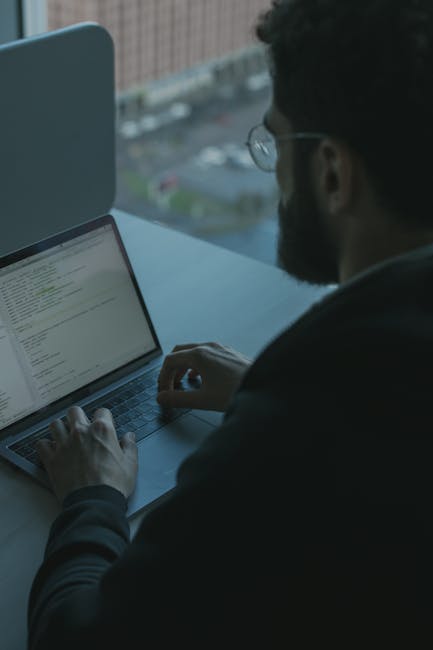 Security team planning a phishing to payload simulation using a laptop and dashboards