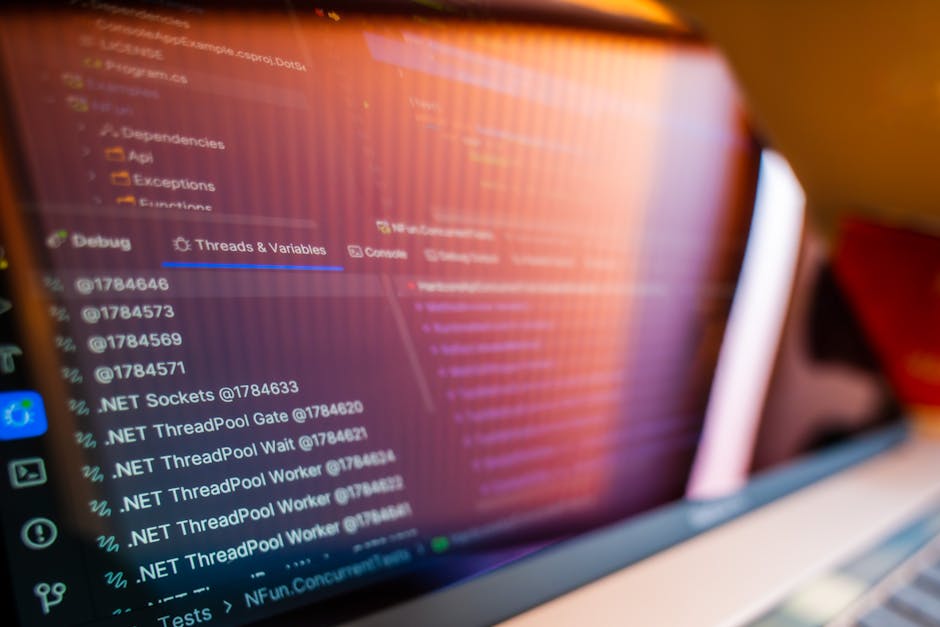Developer reviewing logs and authentication tokens on a laptop, illustrating JWT validation risks