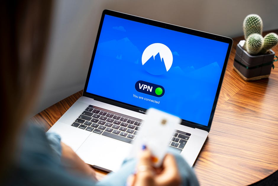 Remote worker connecting to a VPN on a laptop while on a dim home office desk