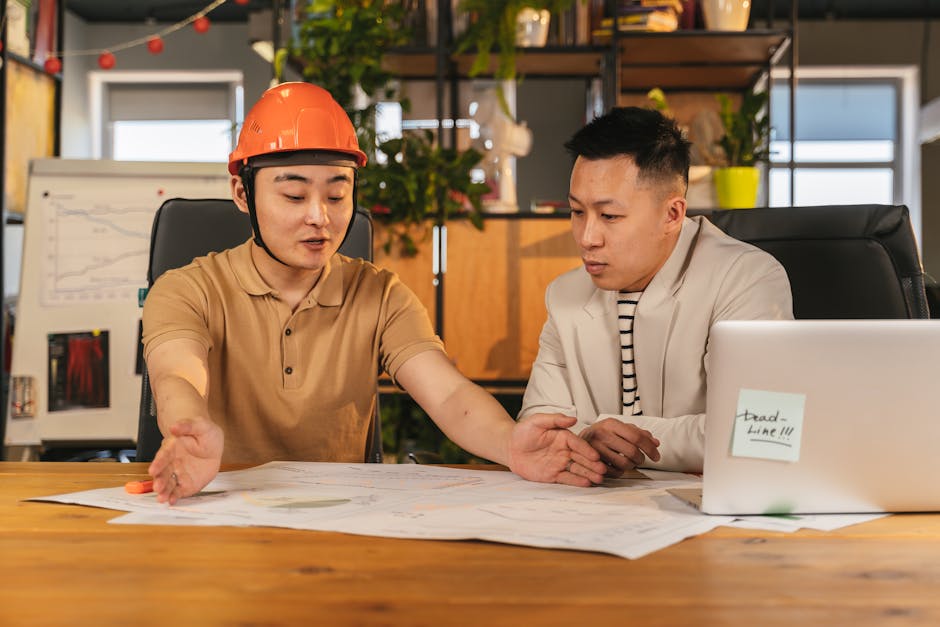 Engineers reviewing a prioritized security action plan with a laptop and notes
