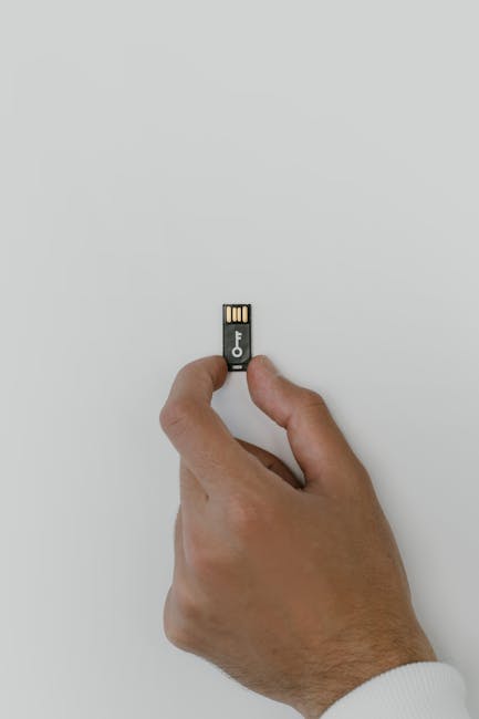 Security key and laptop showing account recovery and passkey migration steps