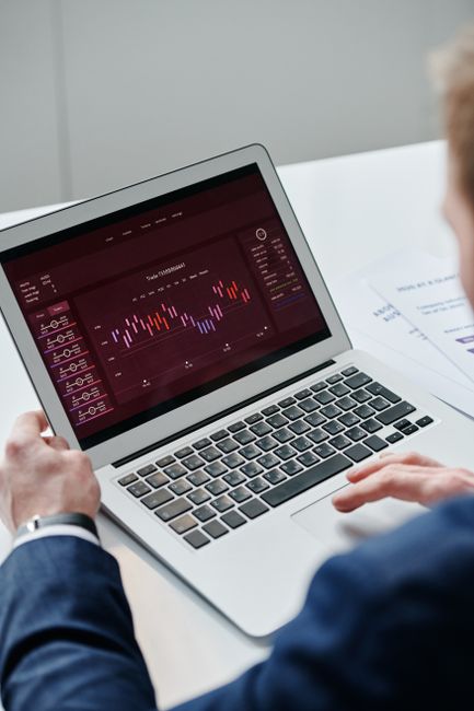 Analyst reviewing a security report on a laptop with notes and evidence screenshots