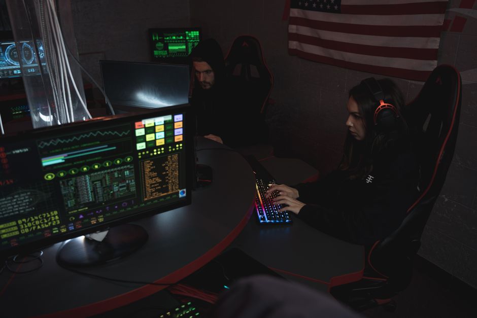Security analyst reviewing detection alerts on multiple screens